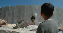 Boy_and_soldier_in_front_of_Israeli_wall